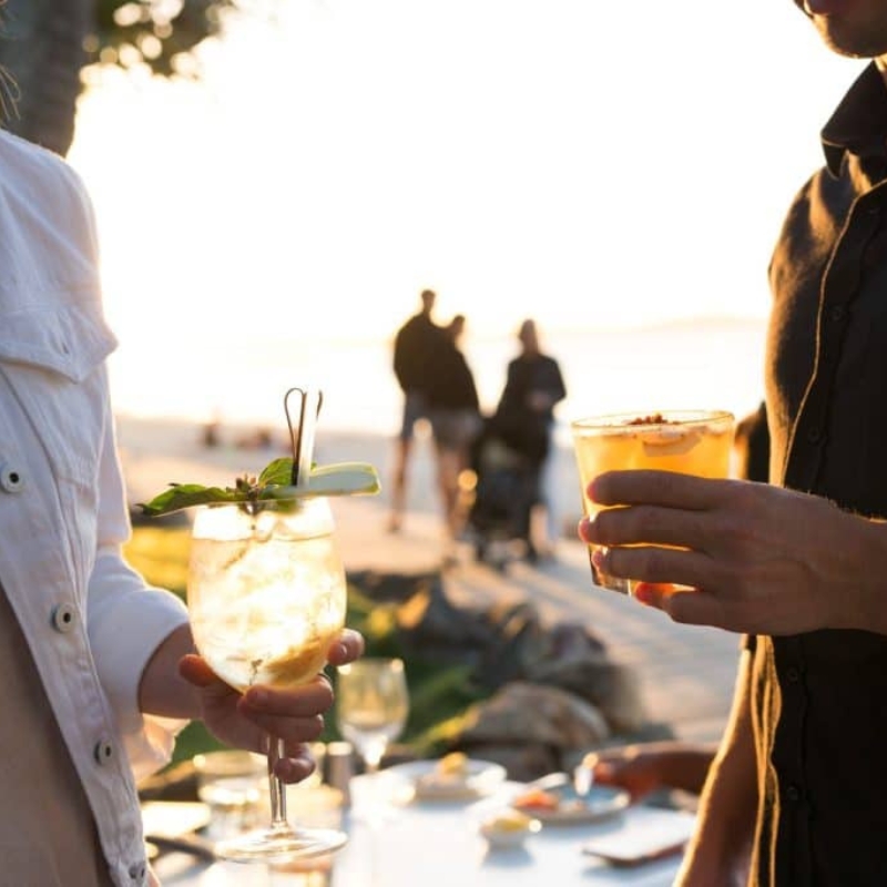 two people holding drinks at bistro c