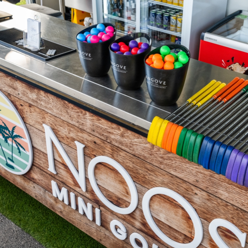 putters and balls at noosa mini golf