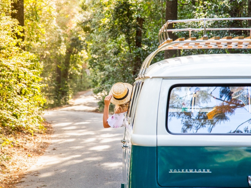 woman leaning out of a van